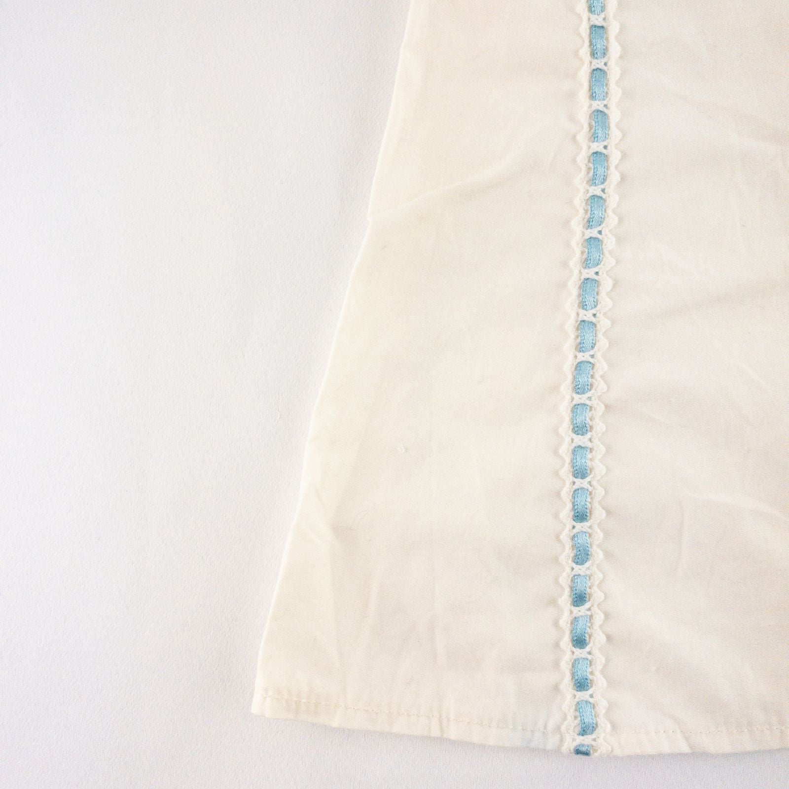 American Girl Caroline cream nightgown dress with blue ribbon detail and matching light blue doll shoes laid flat image 2