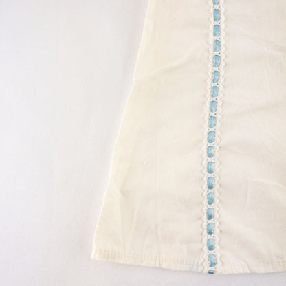American Girl Caroline cream nightgown dress with blue ribbon detail and matching light blue doll shoes laid flat image 2