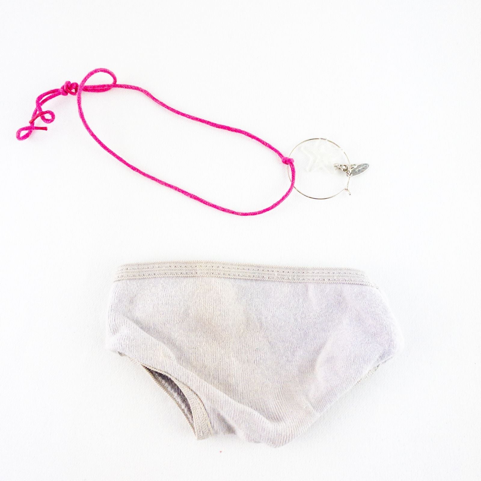 American Girl purple charmed top, matching pants, purple shoes, underwear, and charm necklace doll outfit laid flat image 11