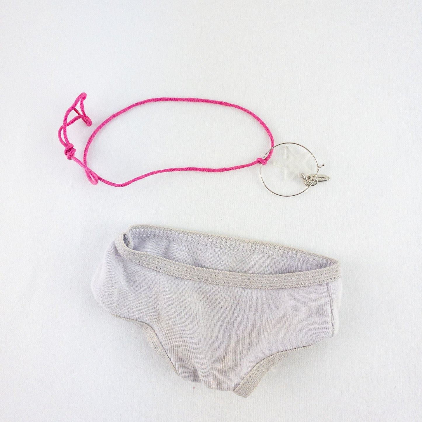 American Girl purple charmed top, matching pants, purple shoes, underwear, and charm necklace doll outfit laid flat image 10