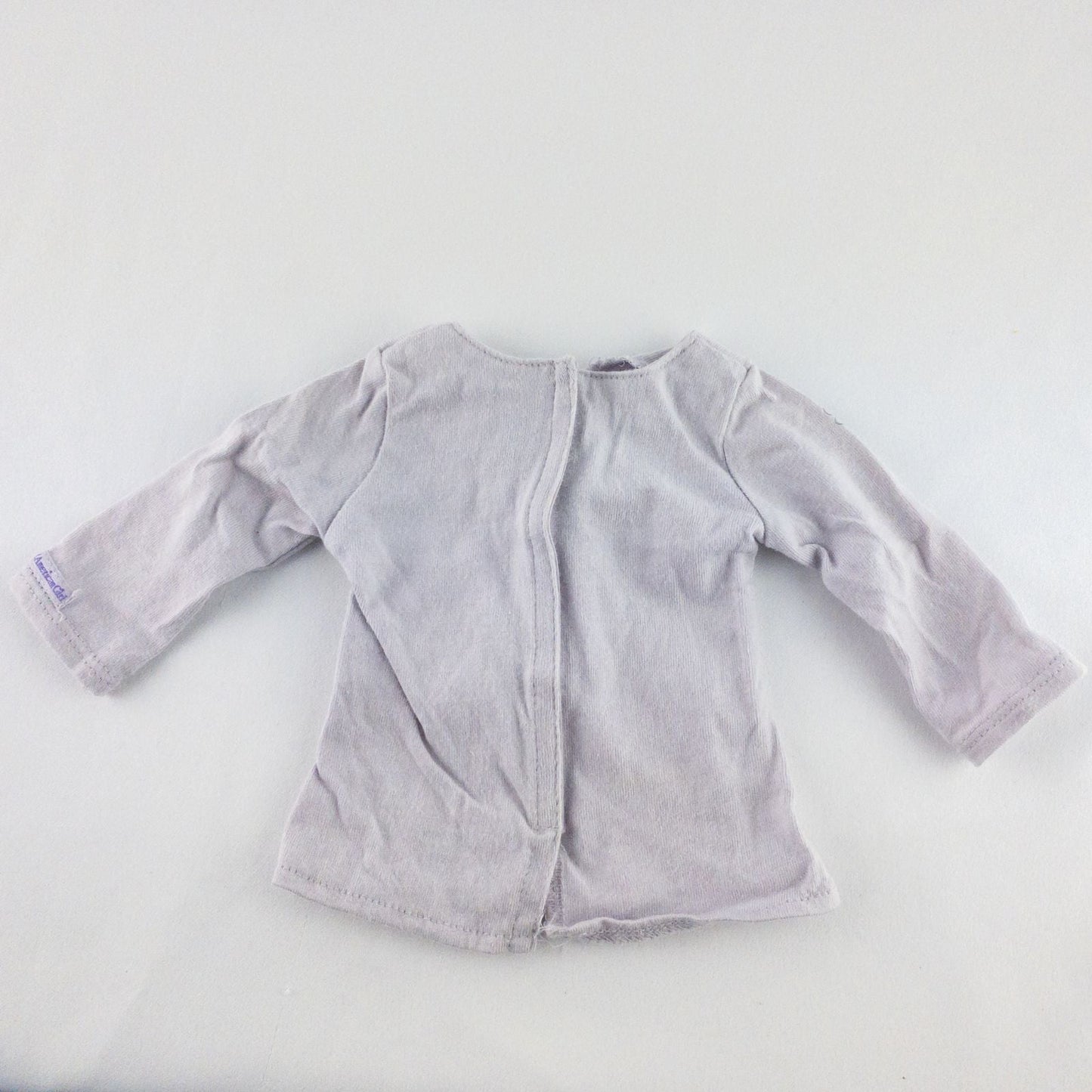 American Girl purple charmed top, matching pants, purple shoes, underwear, and charm necklace doll outfit laid flat image 3