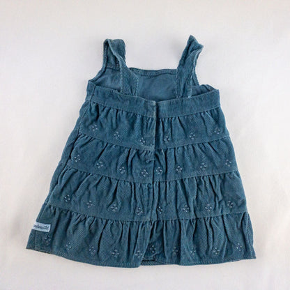 American Girl doll jumper dress outfit with blue corduroy jumper dress, faded light blue long sleeve top, and blue doll boots laid flat on white background image 5