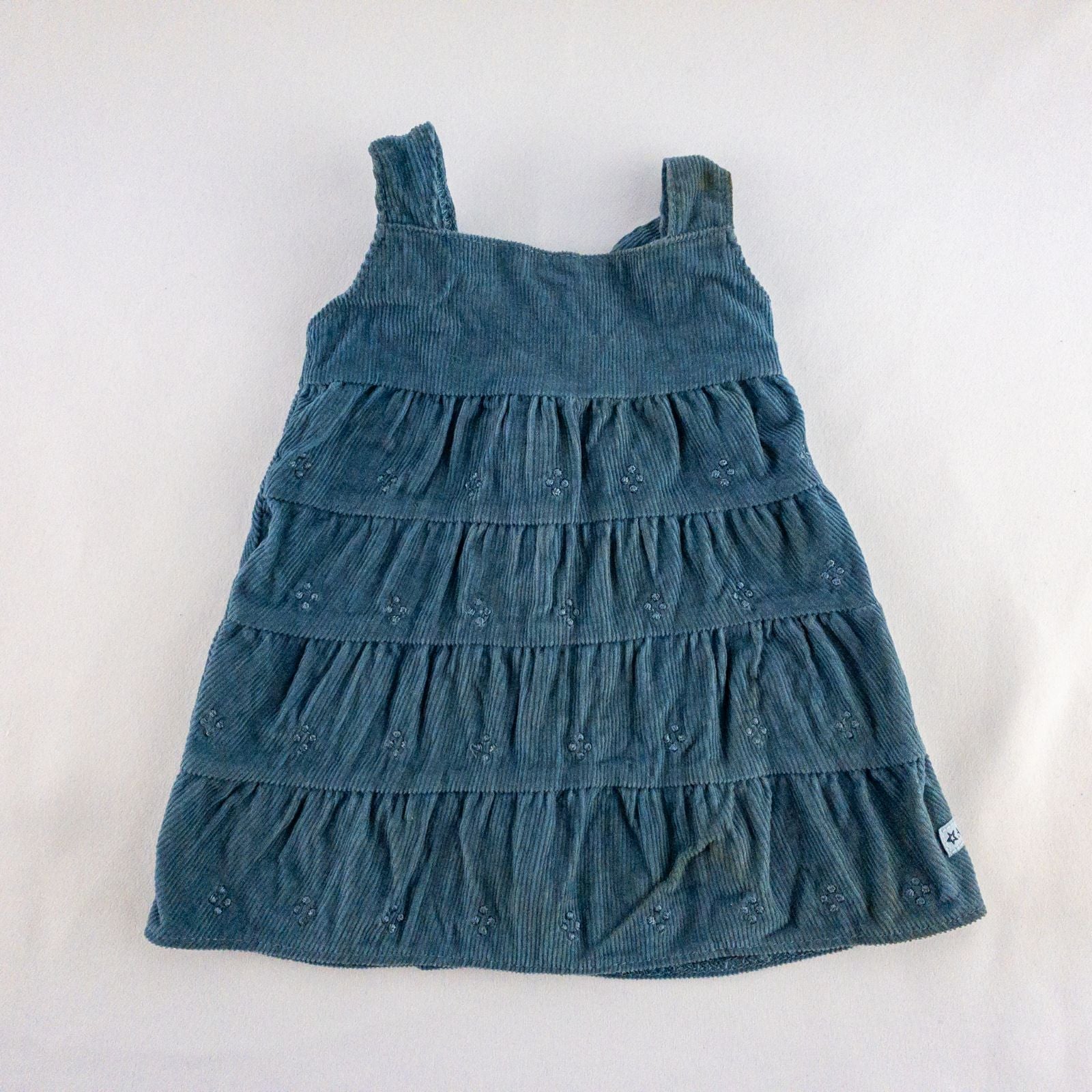 American Girl doll jumper dress outfit with blue corduroy jumper dress, faded light blue long sleeve top, and blue doll boots laid flat on white background image 2