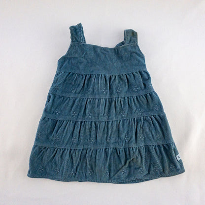 American Girl doll jumper dress outfit with blue corduroy jumper dress, faded light blue long sleeve top, and blue doll boots laid flat on white background image 2