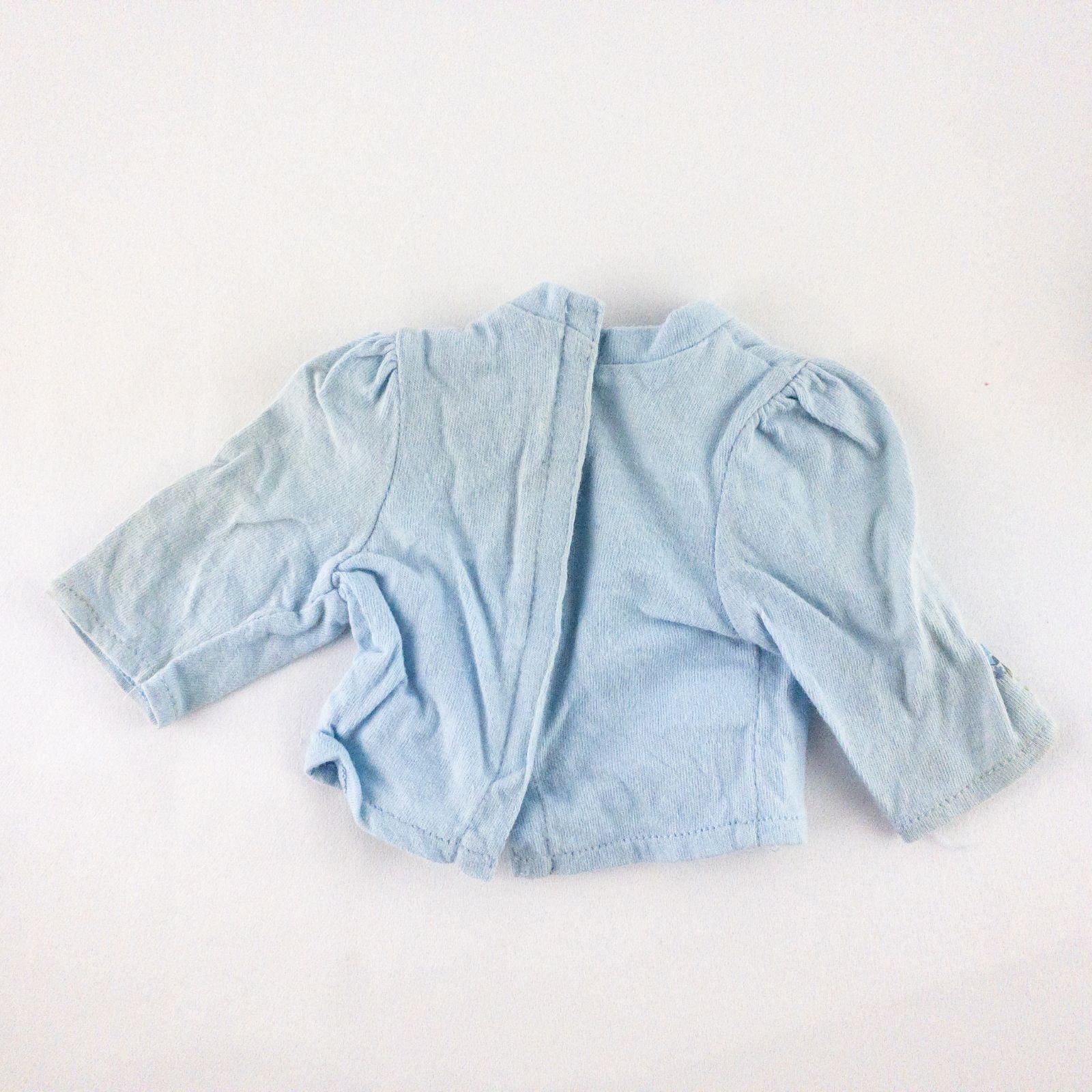 American Girl doll jumper dress outfit with blue corduroy jumper dress, faded light blue long sleeve top, and blue doll boots laid flat on white background image 10