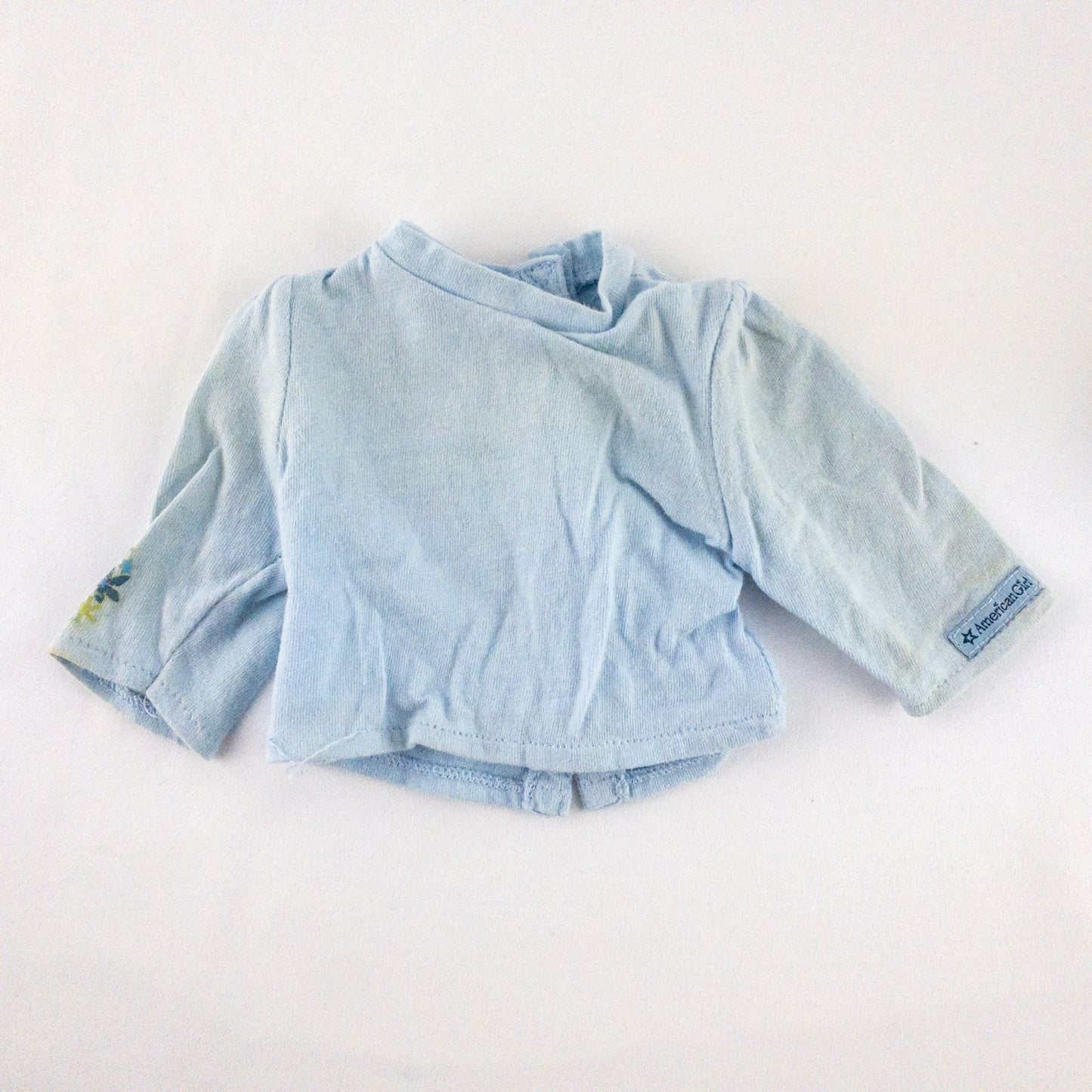 American Girl doll jumper dress outfit with blue corduroy jumper dress, faded light blue long sleeve top, and blue doll boots laid flat on white background image 8