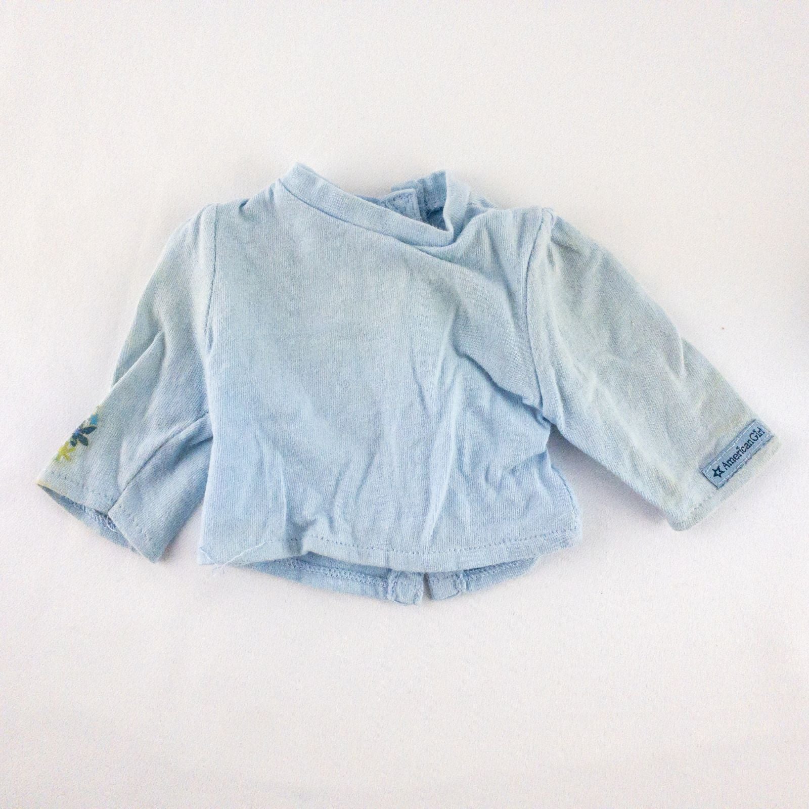 American Girl doll jumper dress outfit with blue corduroy jumper dress, faded light blue long sleeve top, and blue doll boots laid flat on white background image 8