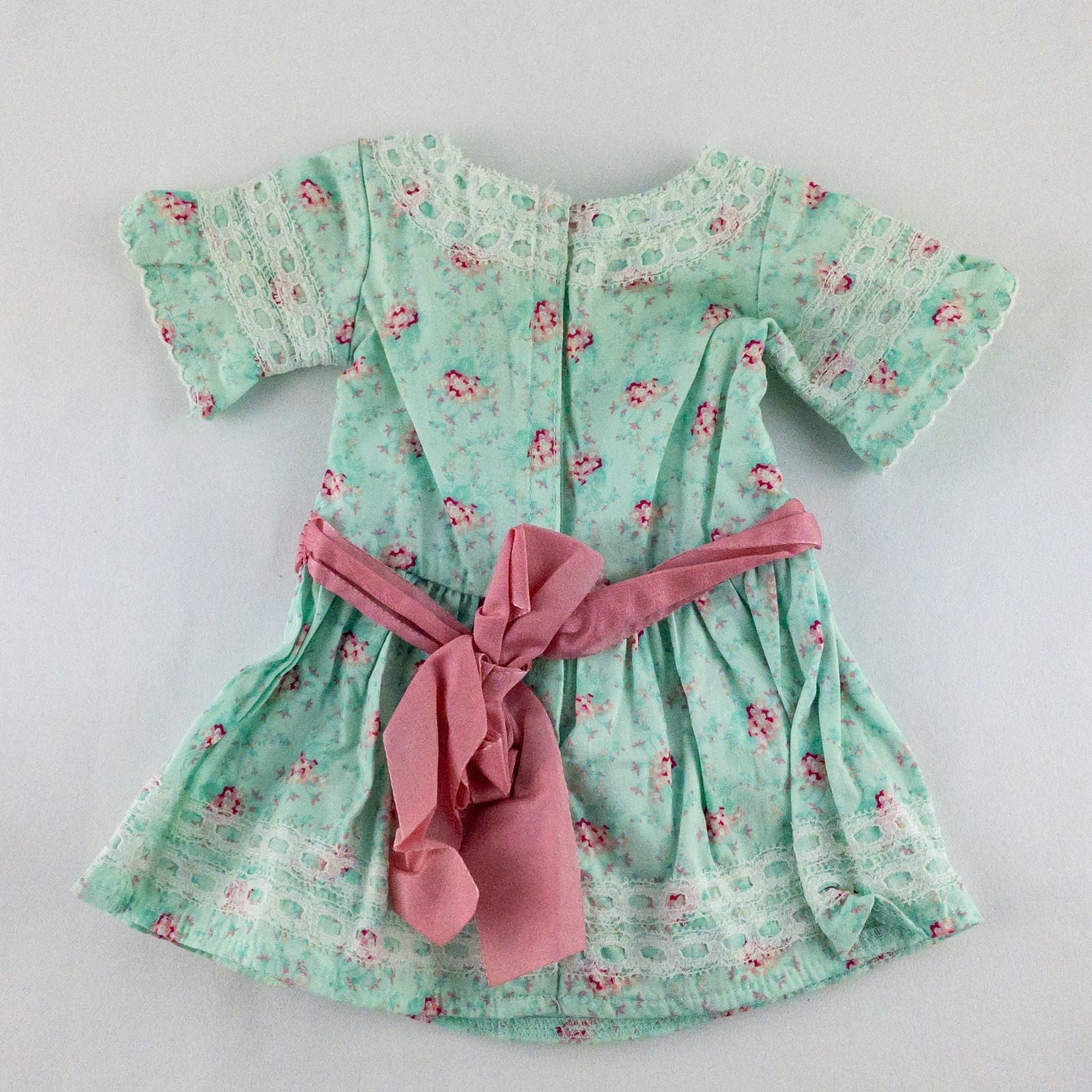 American Girl doll dress set including green floral doll dress with lace trim and pink bow sash, pink bow headband, white stockings, and red patent shoes image 5