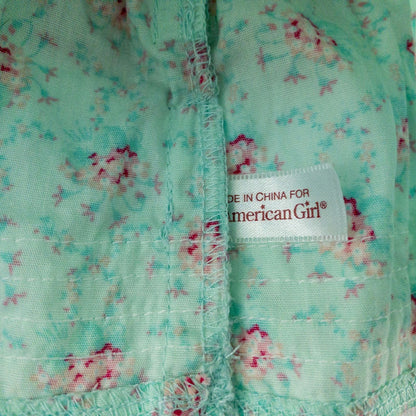 American Girl doll dress set including green floral doll dress with lace trim and pink bow sash, pink bow headband, white stockings, and red patent shoes image 6