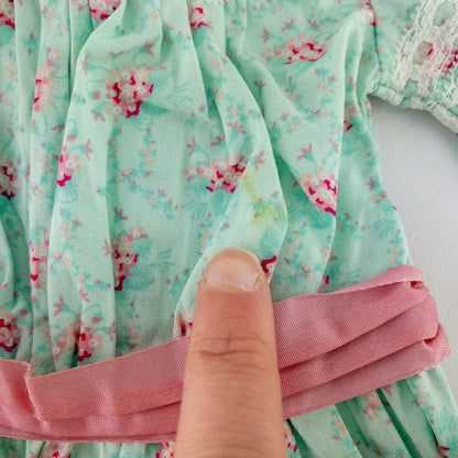American Girl doll dress set including green floral doll dress with lace trim and pink bow sash, pink bow headband, white stockings, and red patent shoes image 3