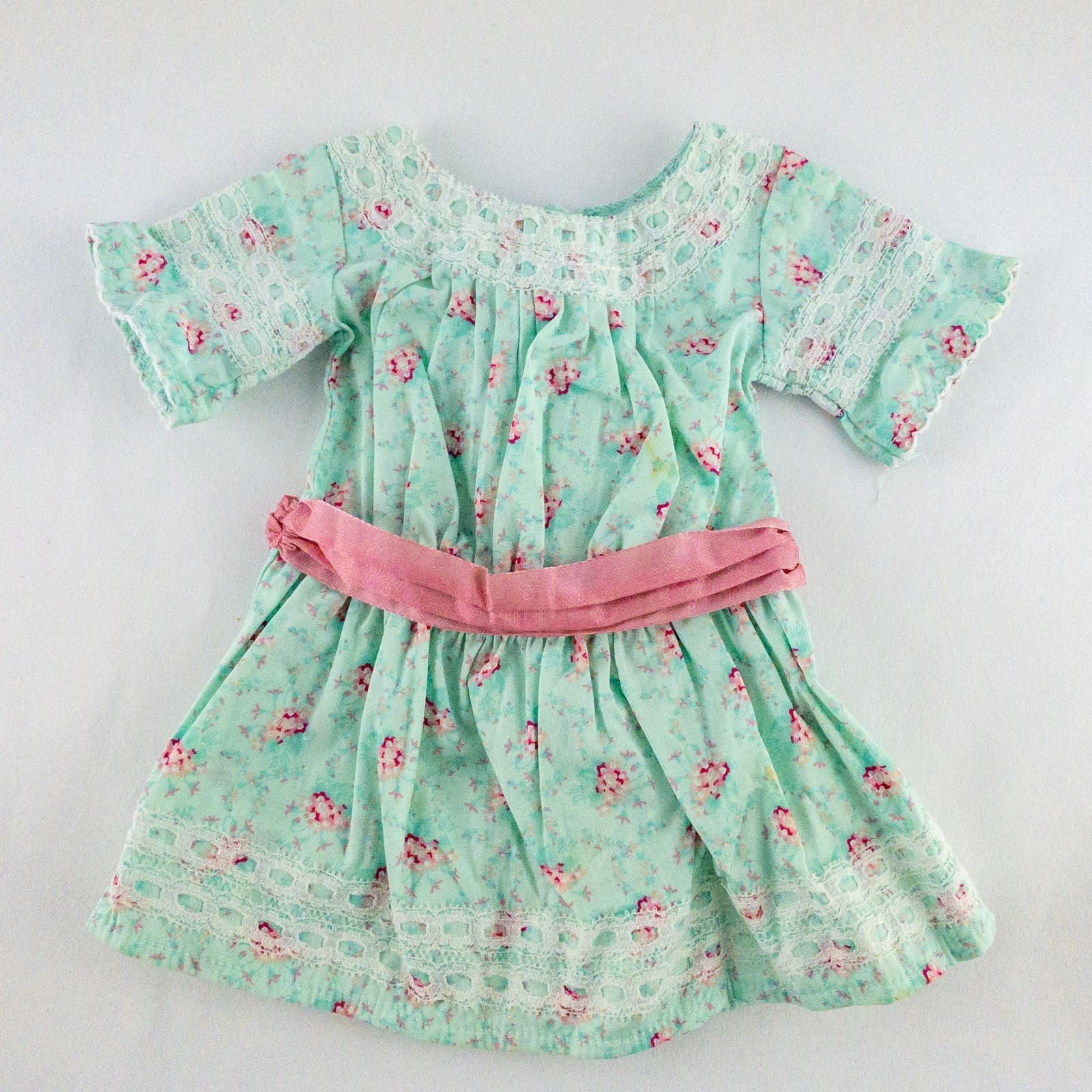 American Girl doll dress set including green floral doll dress with lace trim and pink bow sash, pink bow headband, white stockings, and red patent shoes image 2
