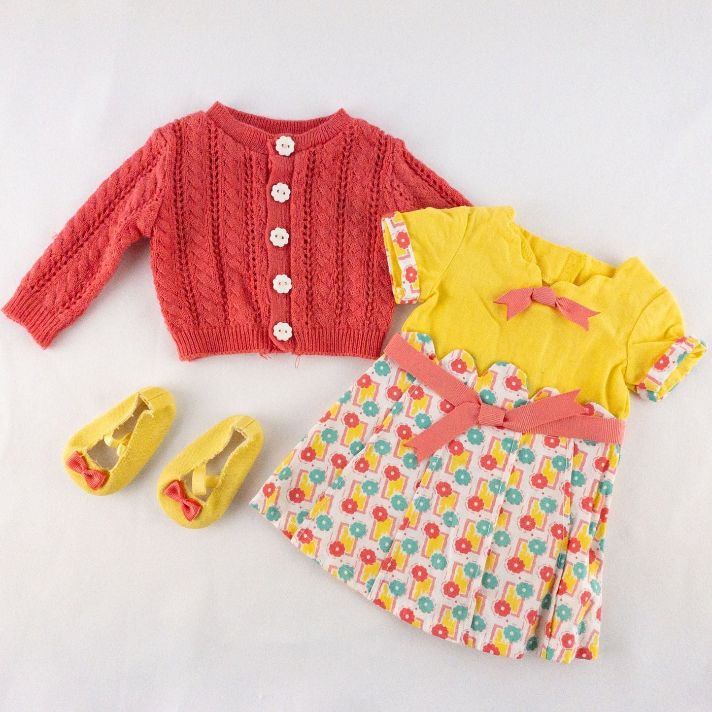 American Girl Kit doll outfit set with yellow floral dress, coral knit cardigan with flower buttons, and yellow shoes with coral bows