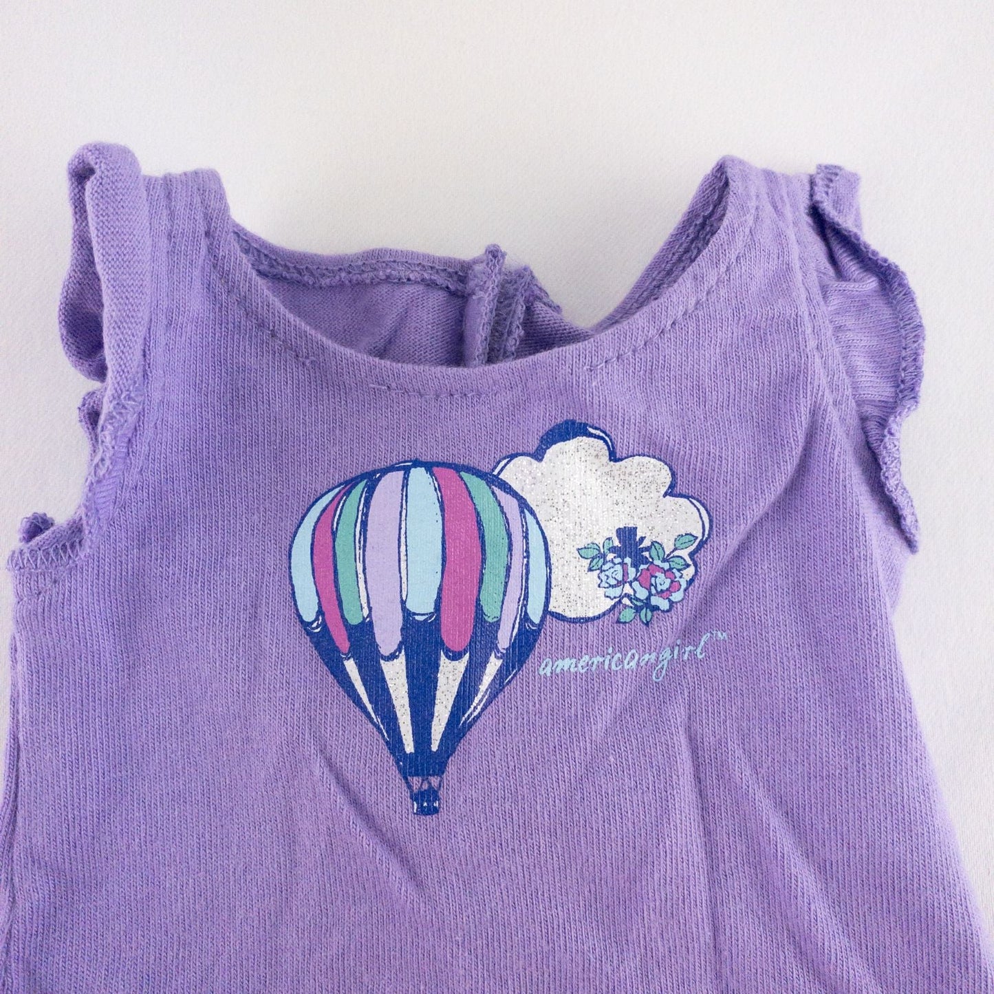 American Girl doll outfit featuring purple sleeveless top with hot air balloon print, matching pajama bottoms with hot air balloons, and pink fuzzy slippers image 2