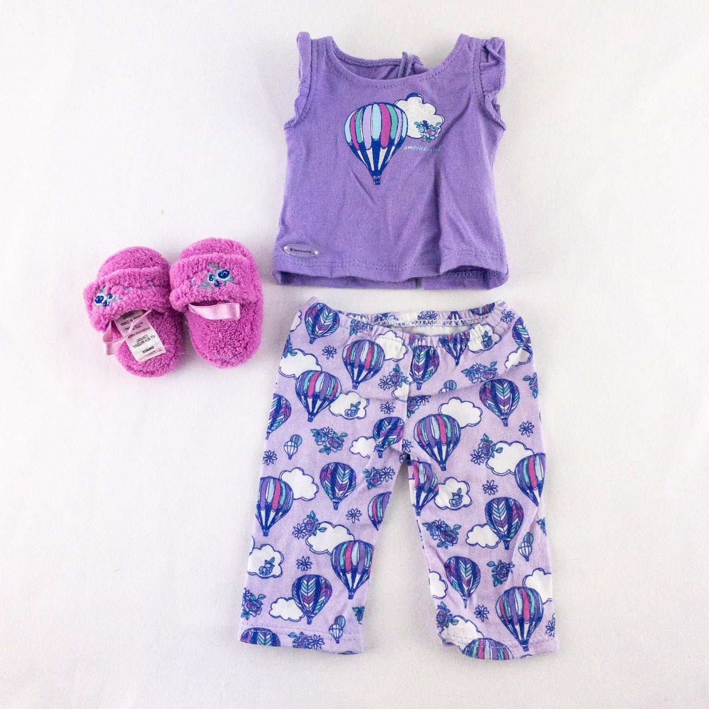 American Girl doll outfit featuring purple sleeveless top with hot air balloon print, matching pajama bottoms with hot air balloons, and pink fuzzy slippers image 9