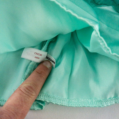 American Girl vintage green emerald doll dress with layered tulle skirt, pink flower belt detail, matching green headband, and red shoes with white bows image 9