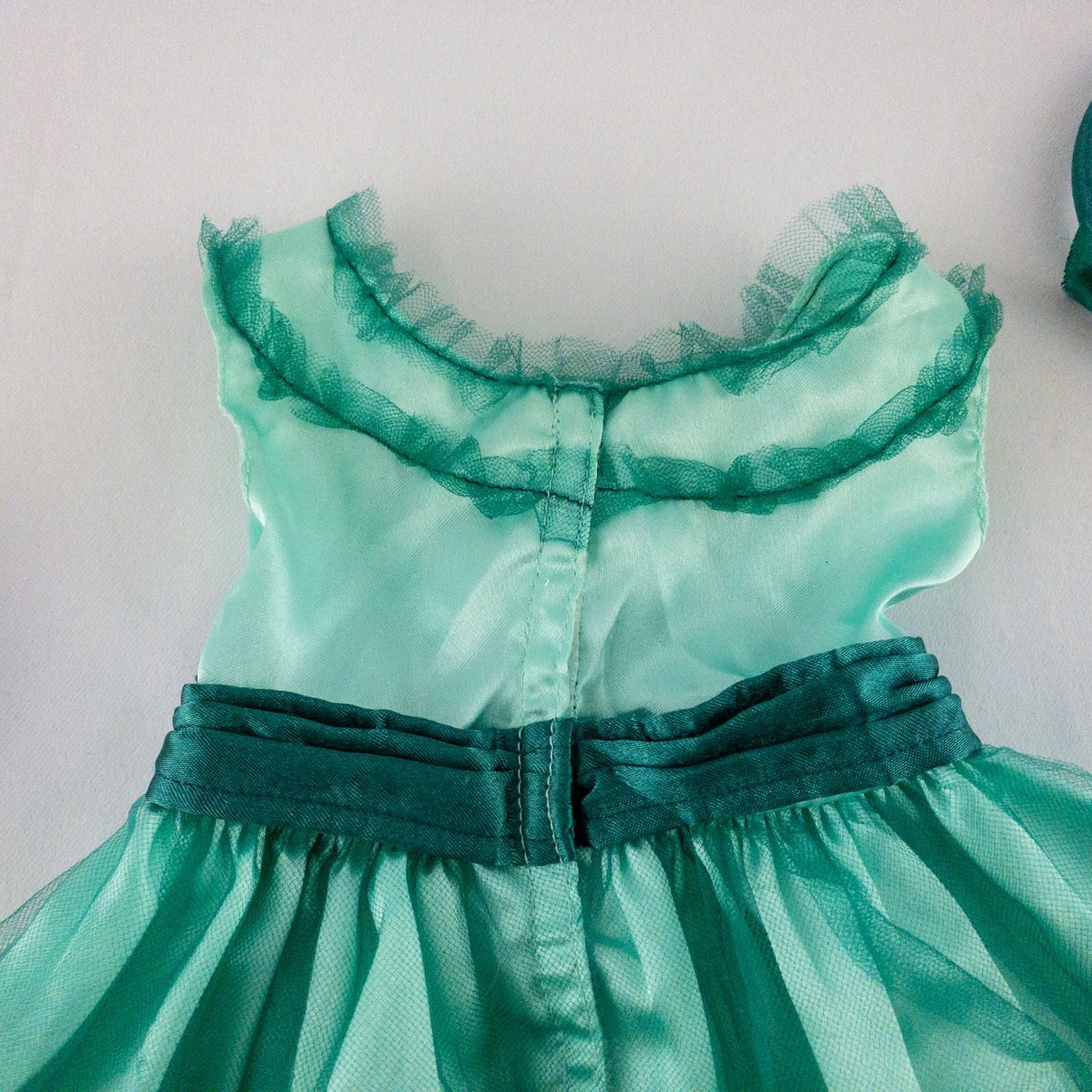 American Girl vintage green emerald doll dress with layered tulle skirt, pink flower belt detail, matching green headband, and red shoes with white bows image 7