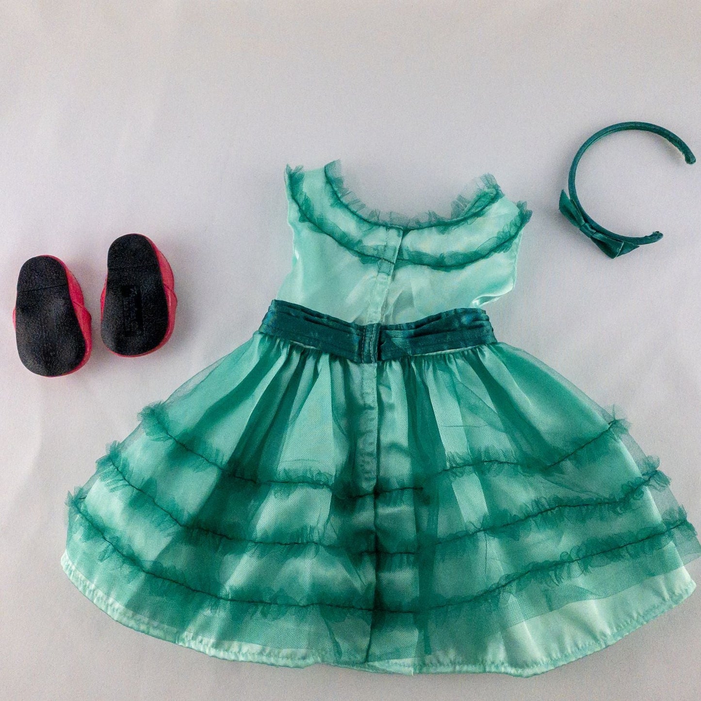 American Girl vintage green emerald doll dress with layered tulle skirt, pink flower belt detail, matching green headband, and red shoes with white bows image 6
