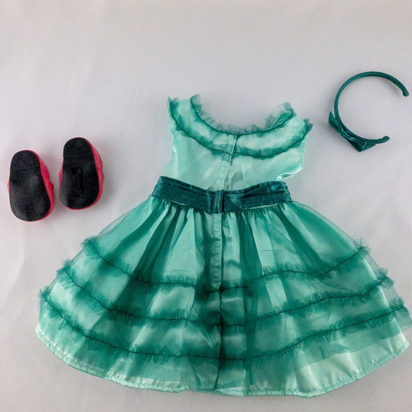 American Girl vintage green emerald doll dress with layered tulle skirt, pink flower belt detail, matching green headband, and red shoes with white bows image 6
