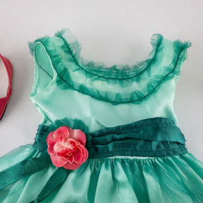 American Girl vintage green emerald doll dress with layered tulle skirt, pink flower belt detail, matching green headband, and red shoes with white bows image 2
