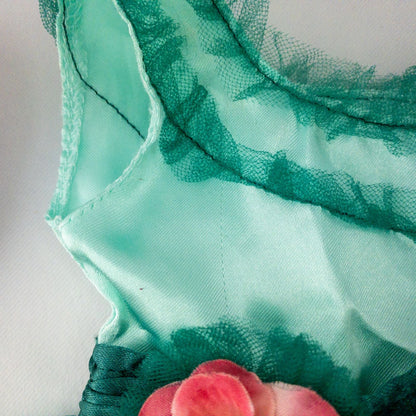 American Girl vintage green emerald doll dress with layered tulle skirt, pink flower belt detail, matching green headband, and red shoes with white bows image 3