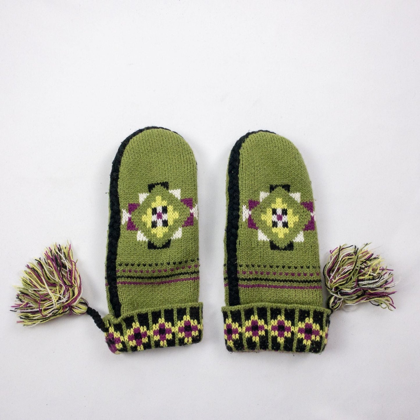 Green and purple fleece lined knit mittens with geometric pattern and tassels