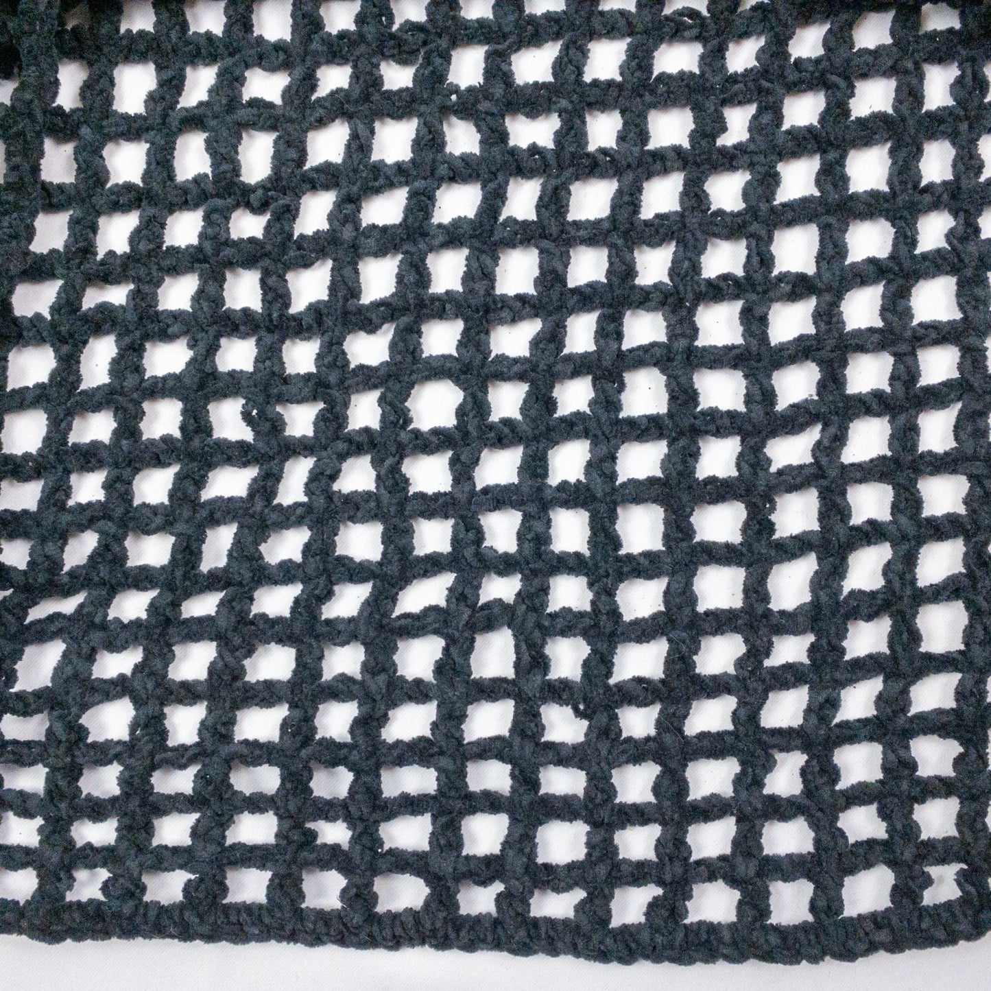 Carla Fernandez black fishnet knit rope sweater with short sleeves displayed on a hanger against a white background image 3