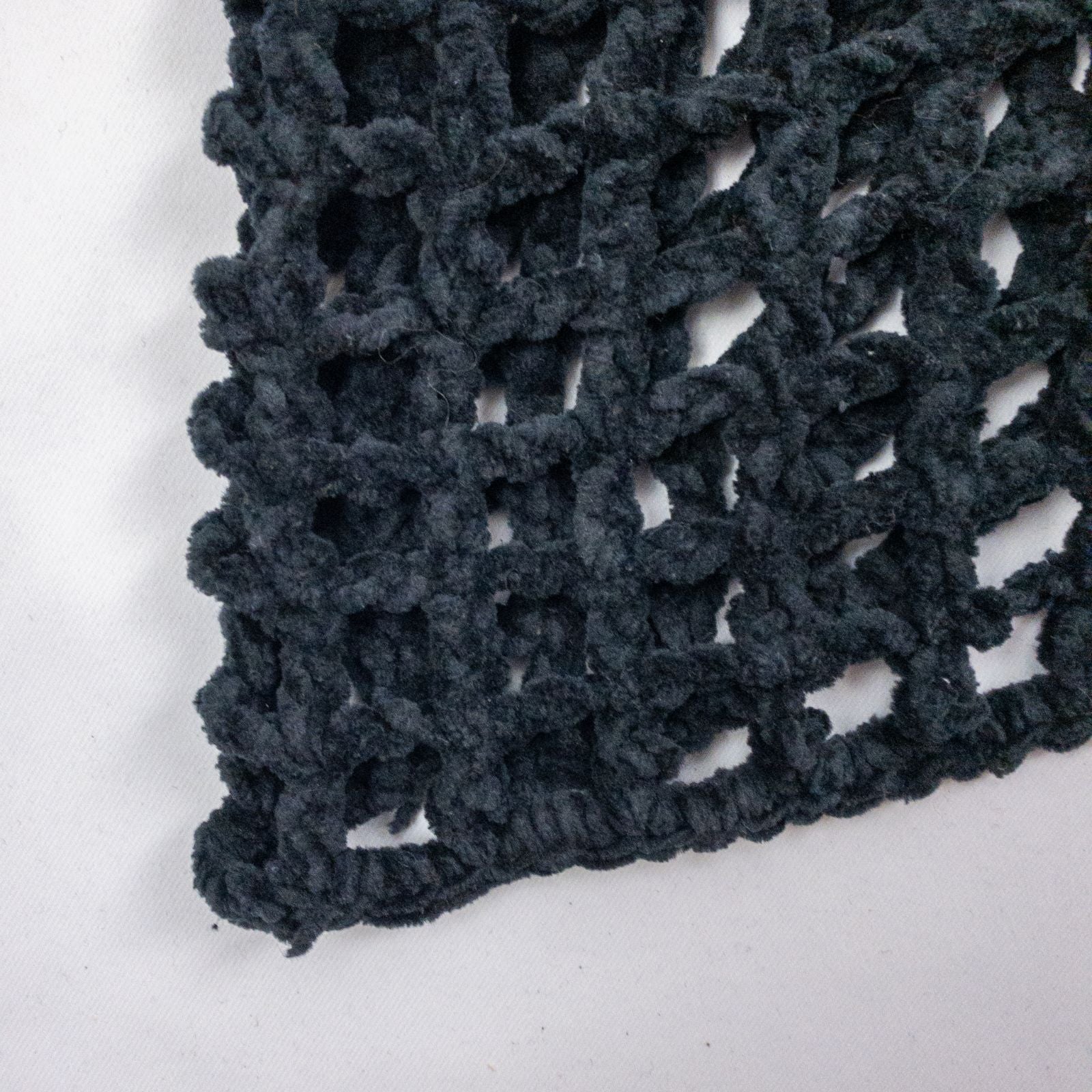 Carla Fernandez black fishnet knit rope sweater with short sleeves displayed on a hanger against a white background image 6