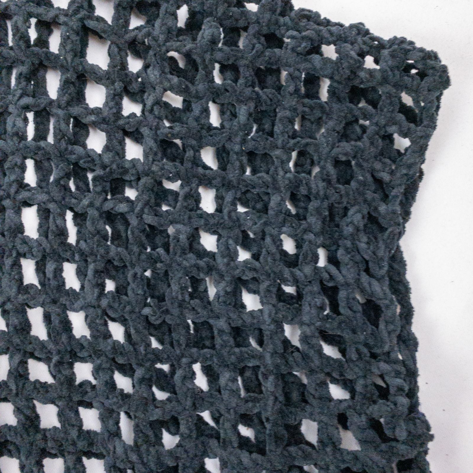 Carla Fernandez black fishnet knit rope sweater with short sleeves displayed on a hanger against a white background image 2