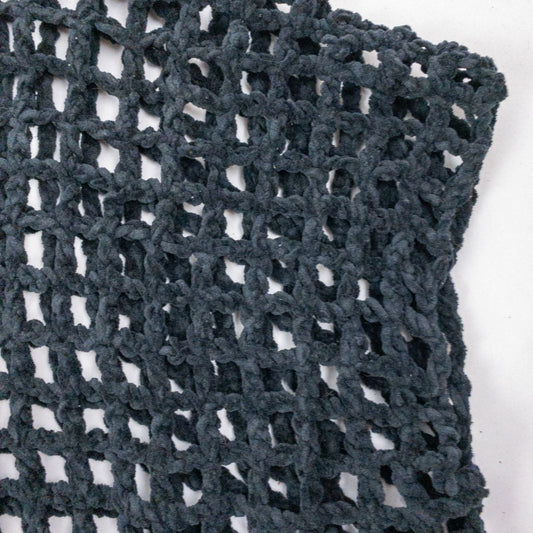 Carla Fernandez black fishnet knit rope sweater with short sleeves displayed on a hanger against a white background image 2