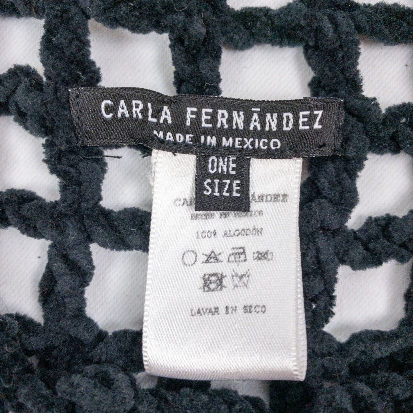 Carla Fernandez black fishnet knit rope sweater with short sleeves displayed on a hanger against a white background image 10