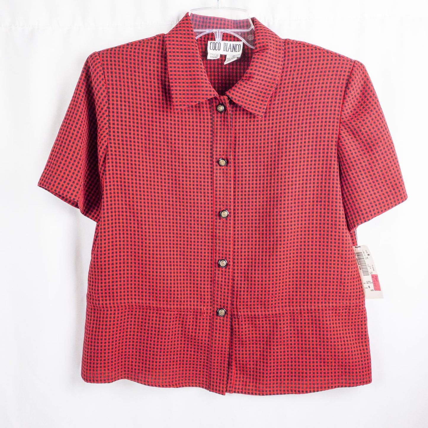 Coco Blanco vintage red and black checkered shirt with ornate buttons and short sleeves on hanger