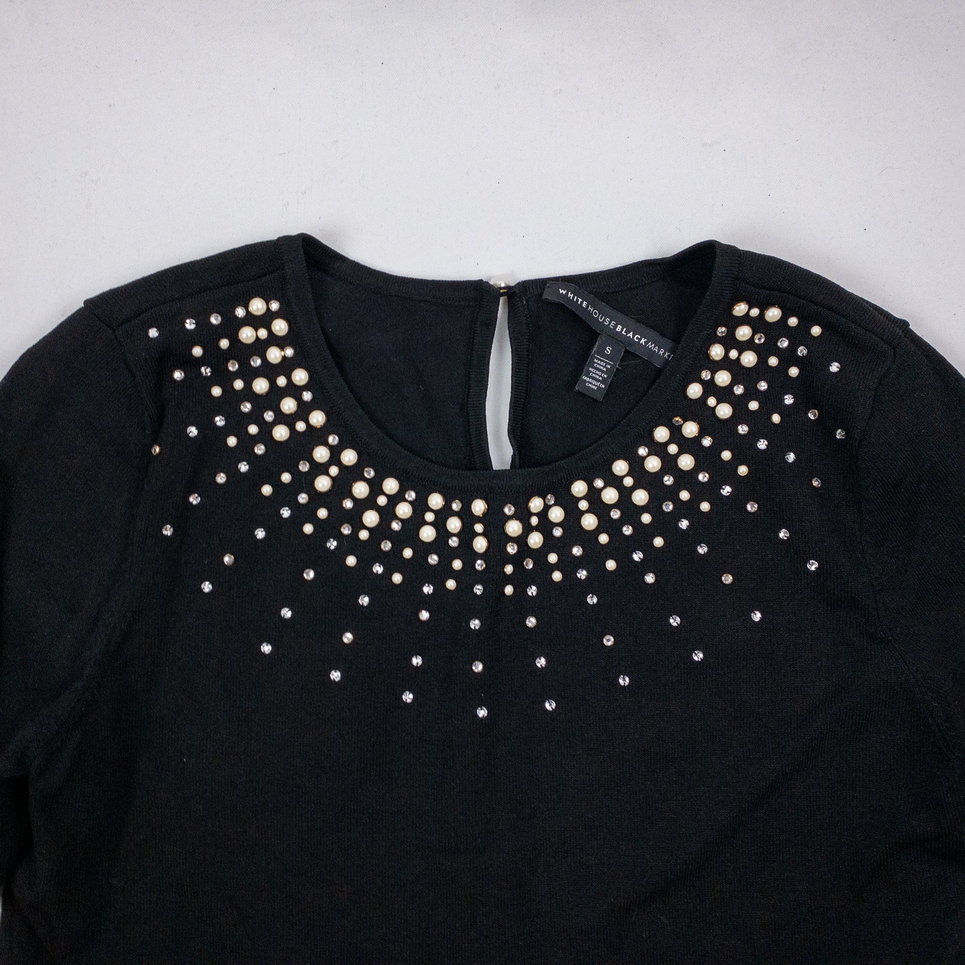Black White House Black Market sweater with pearl and rhinestone neckline embellishments and 3/4 sleeves