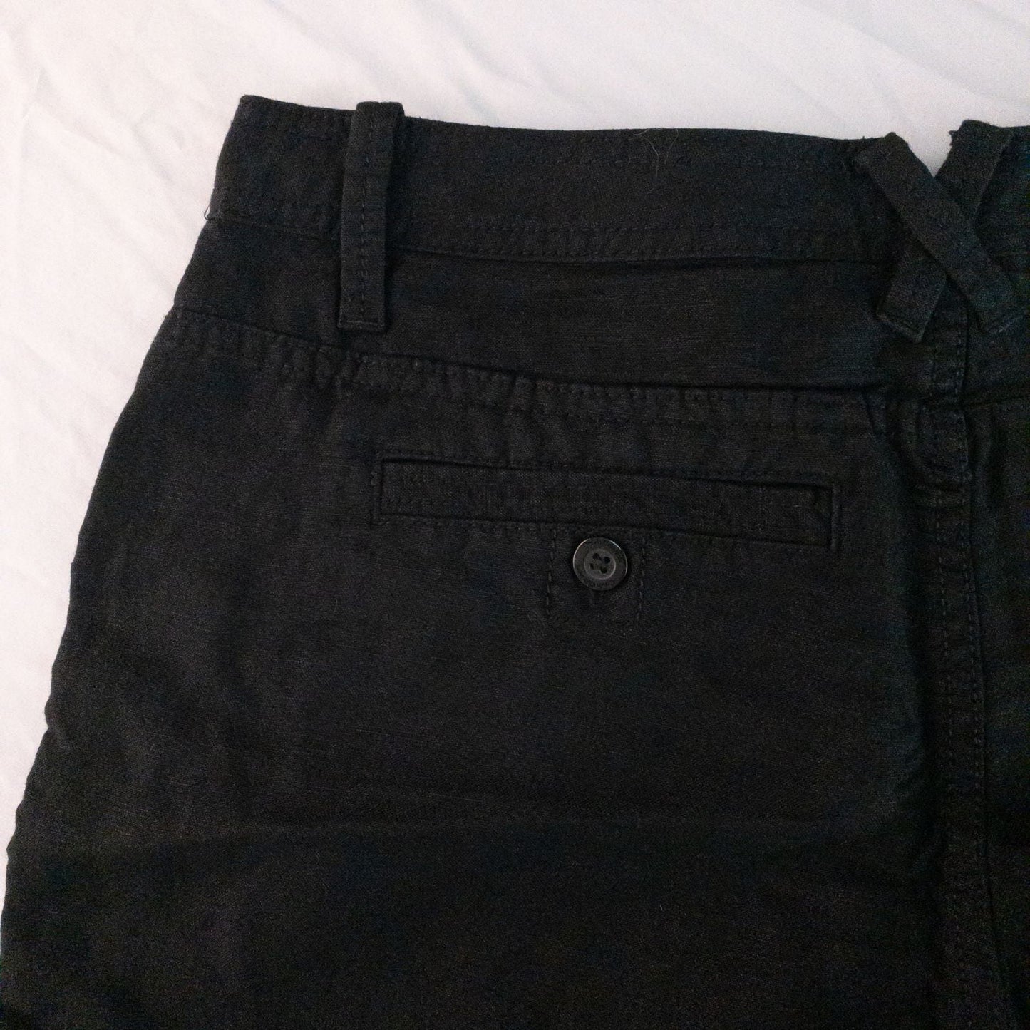 Calvin Klein black linen women's shorts size 4 with button details and front and back pockets displayed on white background image 6