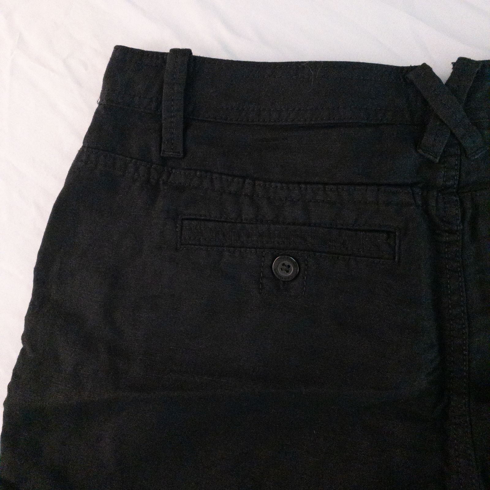 Calvin Klein black linen women's shorts size 4 with button details and front and back pockets displayed on white background image 6