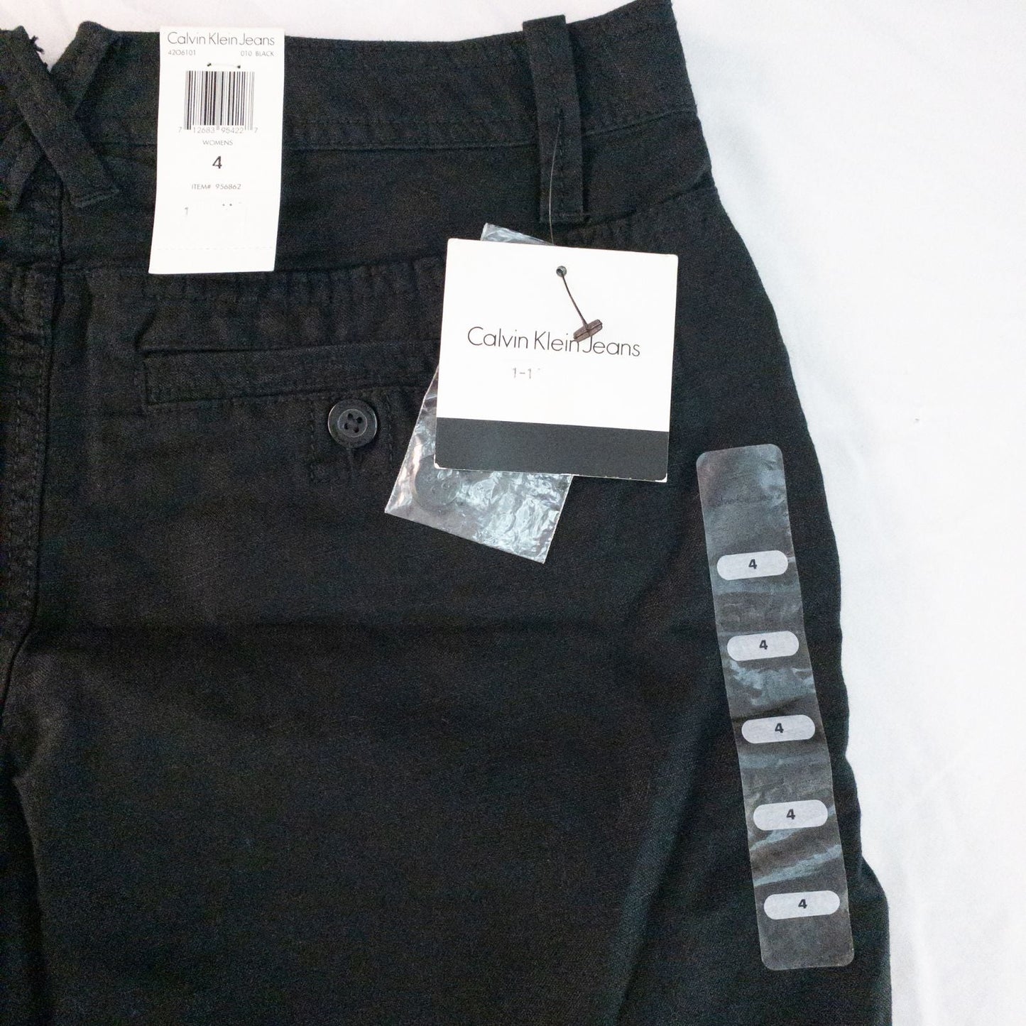 Calvin Klein black linen women's shorts size 4 with button details and front and back pockets displayed on white background image 10