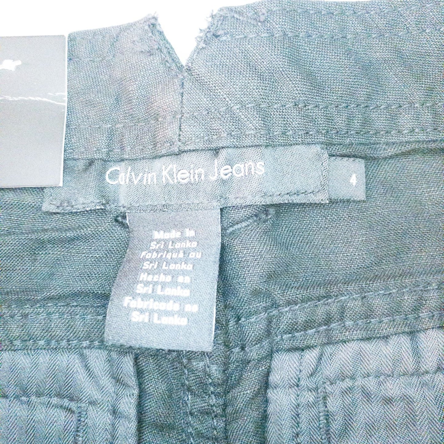 Calvin Klein black linen women's shorts size 4 with button details and front and back pockets displayed on white background image 8