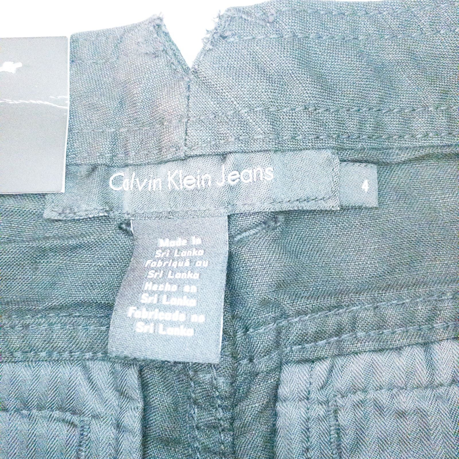 Calvin Klein black linen women's shorts size 4 with button details and front and back pockets displayed on white background image 8