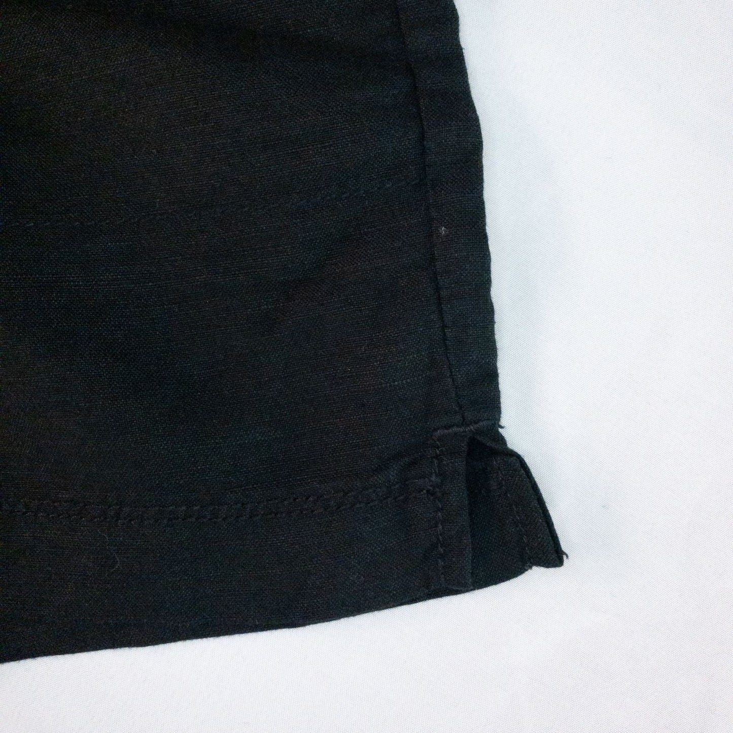 Calvin Klein black linen women's shorts size 4 with button details and front and back pockets displayed on white background image 4