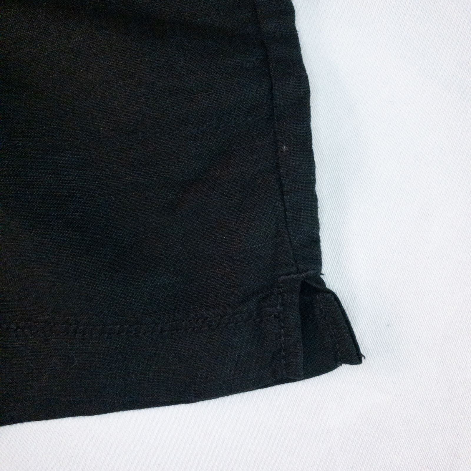 Calvin Klein black linen women's shorts size 4 with button details and front and back pockets displayed on white background image 4