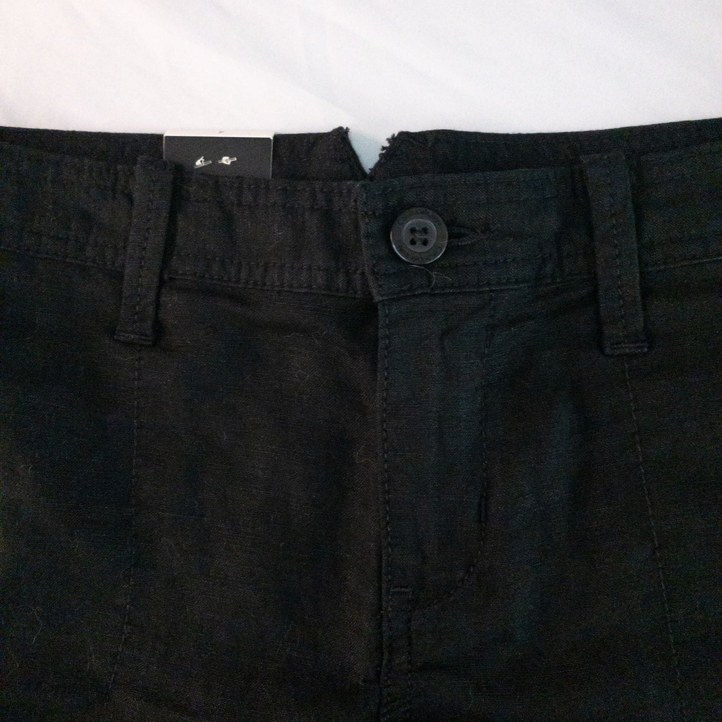 Calvin Klein black linen women's shorts size 4 with button details and front and back pockets displayed on white background image 2