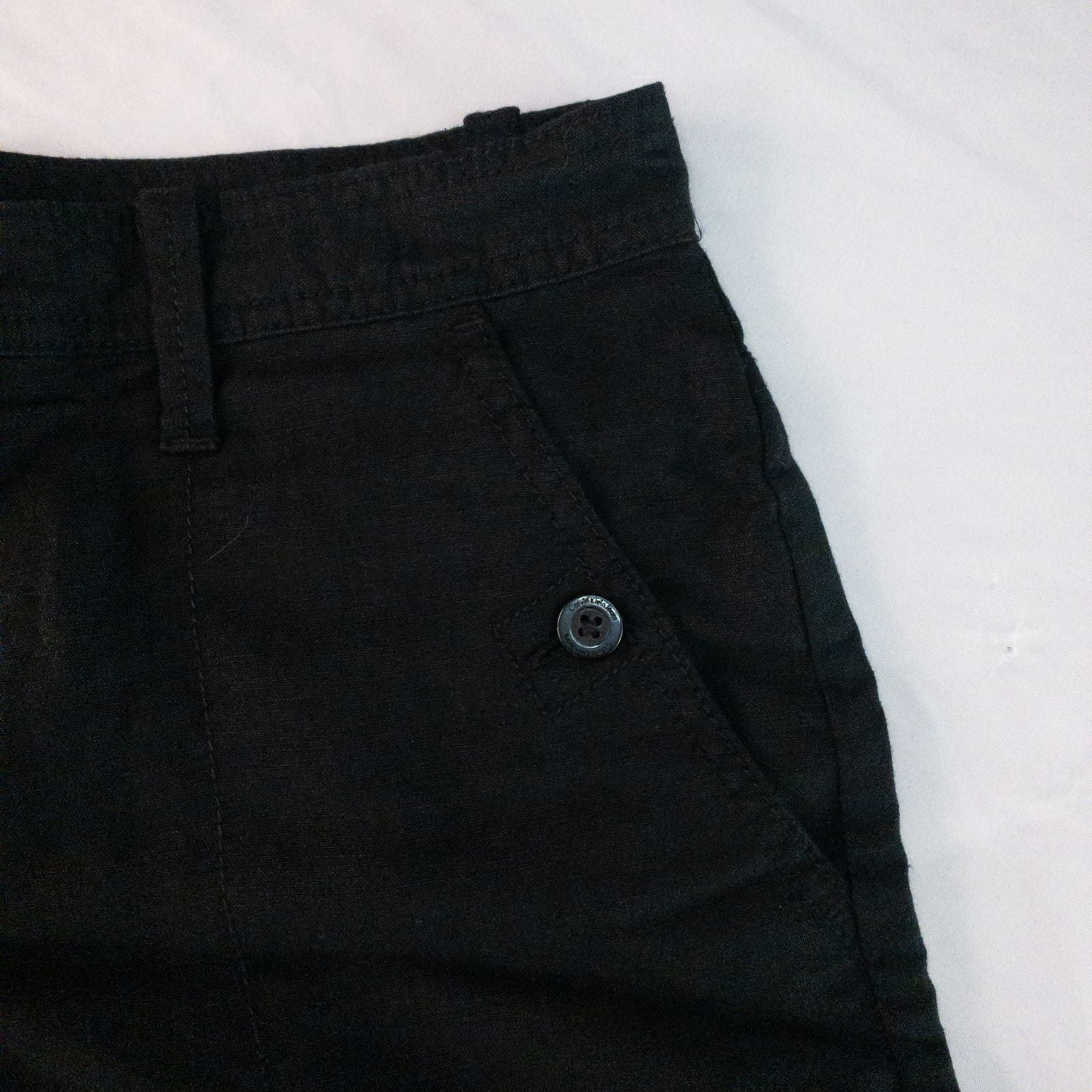 Calvin Klein black linen women's shorts size 4 with button details and front and back pockets displayed on white background image 3