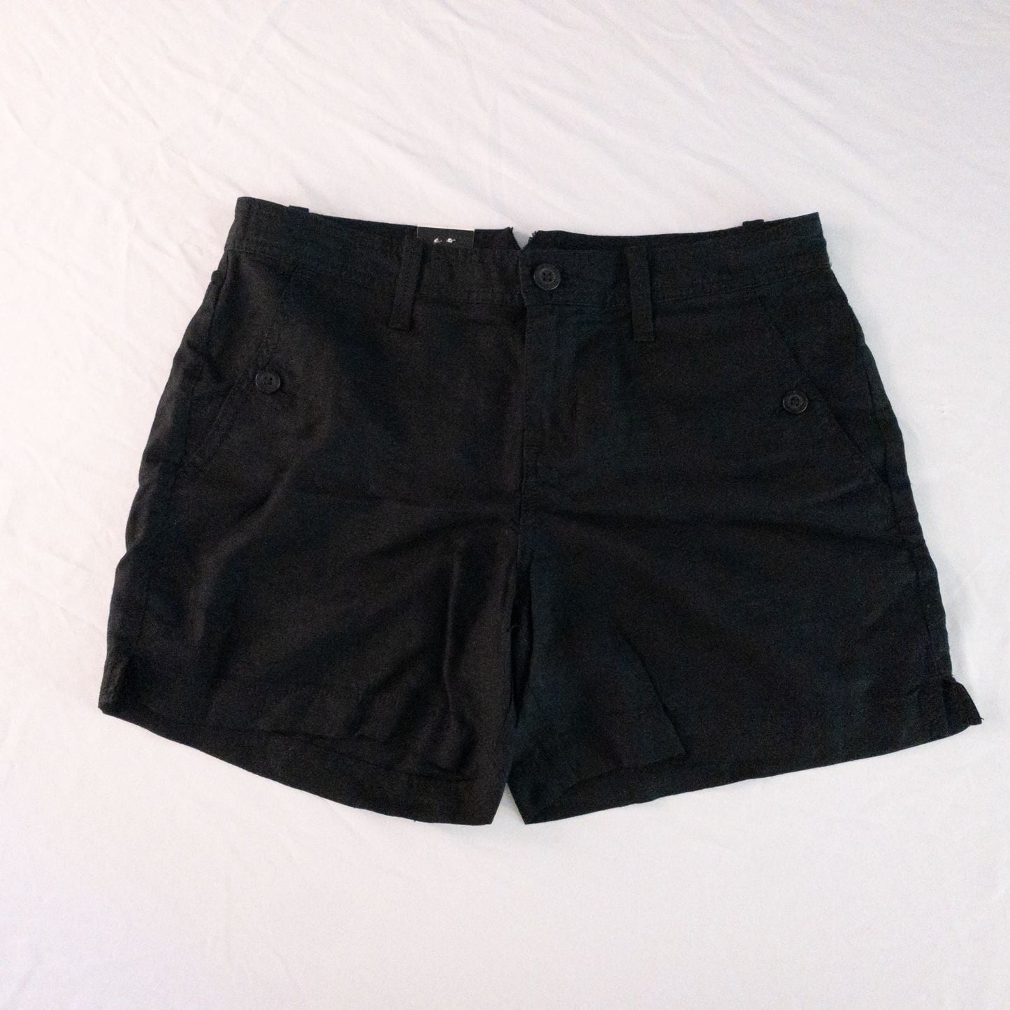 Calvin Klein black linen women's shorts size 4 with button details and front and back pockets displayed on white background