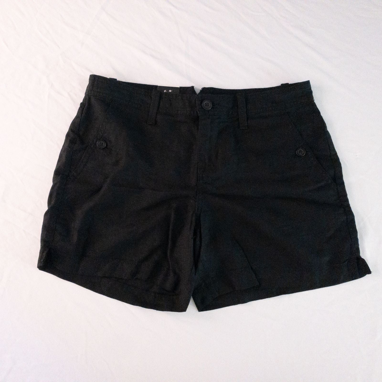 Calvin Klein black linen women's shorts size 4 with button details and front and back pockets displayed on white background