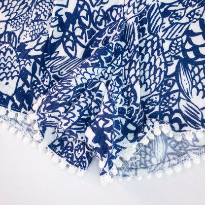 Lily Pullitzer blue fish print lounge shorts with pom pom trim and drawstring waistband laid flat image 5