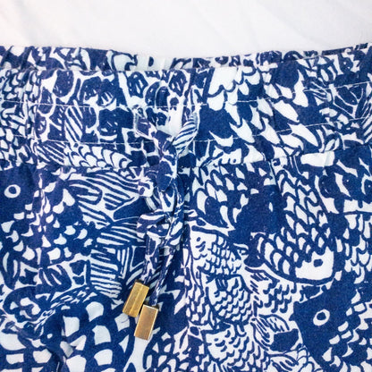 Lily Pullitzer blue fish print lounge shorts with pom pom trim and drawstring waistband laid flat image 4