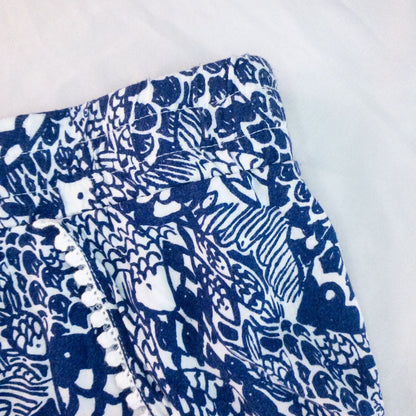 Lily Pullitzer blue fish print lounge shorts with pom pom trim and drawstring waistband laid flat image 3