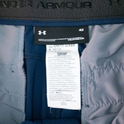 Under Armour navy men's shorts laid flat showing front and back views with button and logo details image 10
