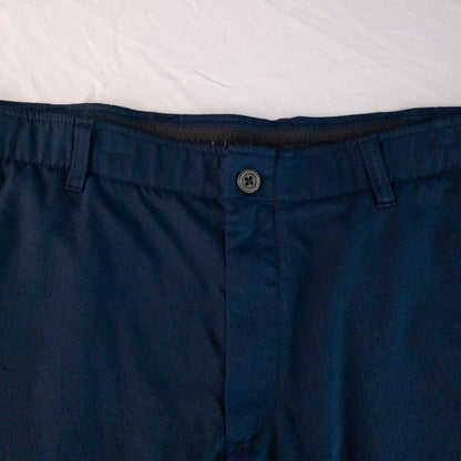 Under Armour navy men's shorts laid flat showing front and back views with button and logo details image 2