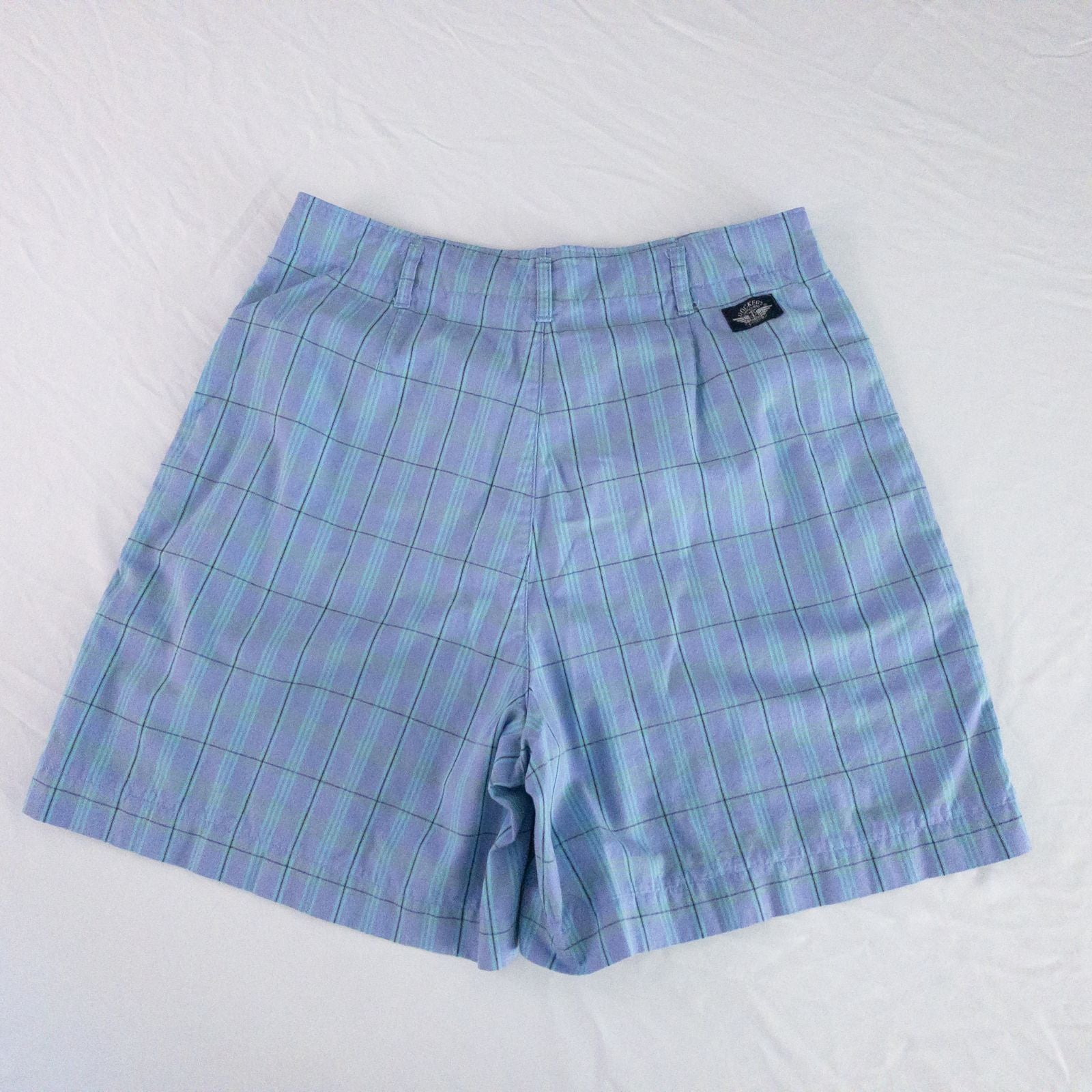 Levis Dockers purple plaid women's shorts laid flat showing front, side pockets, waistband details, and small wear dot image 8