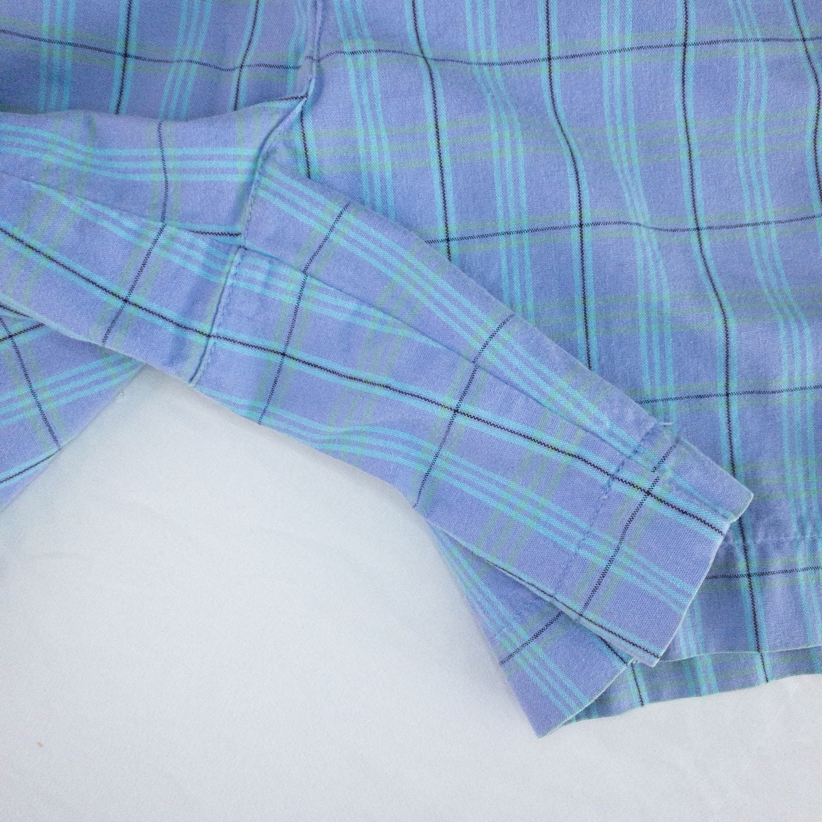 Levis Dockers purple plaid women's shorts laid flat showing front, side pockets, waistband details, and small wear dot image 4